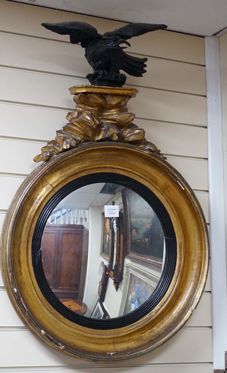 A Regency ebonised and giltwood convex wall mirror, height 87cm *Please note the sale commences at 9am.
